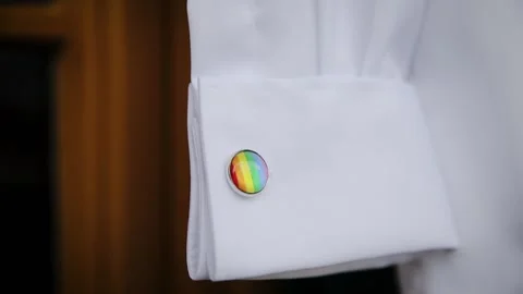 Cufflink emblem with pride rainbow flag. LGBT wedding preparation. Symbol of gay Stock Footage 204123863