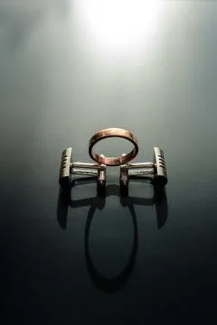 Cufflinks on a black background with a light effect 스톡 사진