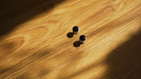 Cufflinks at wooden background Stock Footage 96989859