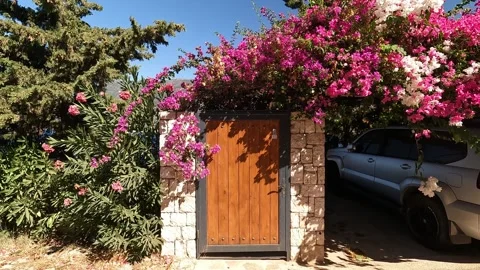 Cukurbag, Kas, Turkey - August 29, 2026 Wooden gate under bougainvillea Stock Footage 344879133