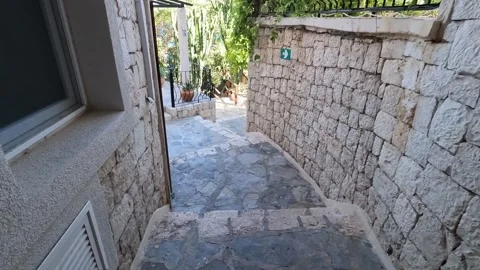 Cukurbag, Kas, Turkey - August 29, 2026 Walking down stairs to pool Stock Footage 344879473