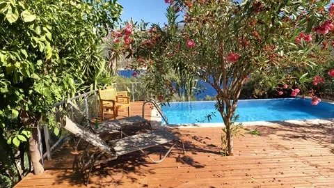 Cukurbag, Kas, Turkey - August 29, 2026 Hotel pool and deck in wind Stock Footage 344879625