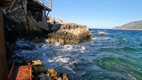 Cukurbag, Kas, Turkey - August 29, 2026 Waves crashing at pier Stock Footage 344880105