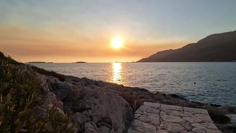 Cukurbag, Kas, Turkey - August 29, 2026 Sunset over the sea and rocky coast Stock Footage 345139229