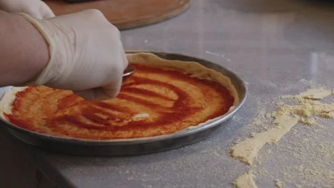 Culinary Artistry Unleashed: Chef's Hands Craft Delicious Pizza with Precision Stock Footage 259179635