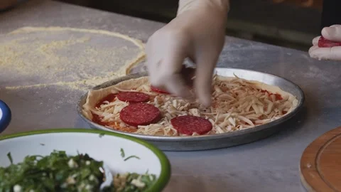 Culinary Artistry Unleashed: Chef's Hands Craft Delicious Pizza with Precision Stock Footage 259405656