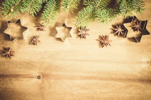 Culinary background. Cutters for cookie, anise and branch of Christmas tree. Stock Photos