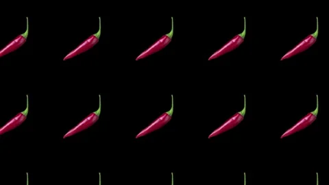 A culinary background featuring spicy red peppers with rotation. On a black b Stock Footage 345582709