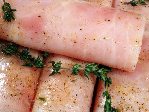 Culinary background. Ham rolled in rolls with spices 写真素材