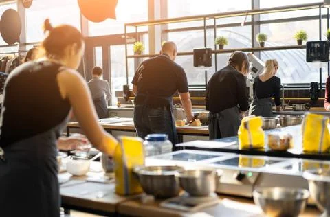 Culinary class. Back view of the process of cooking. Different unrecognizable Foto stock