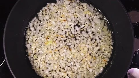Culinary cooking concept. Finely chopped golden onion is fried in a pan. Video stock 202239965