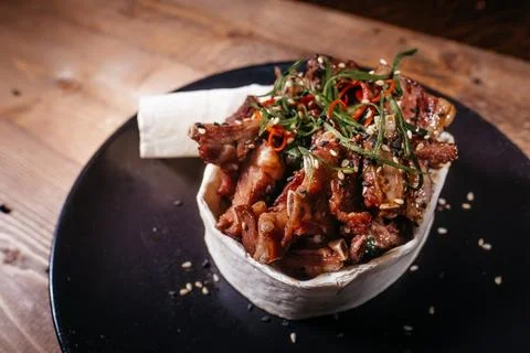 A culinary delight, juicy and tender meat combined with fresh vegetables and  Stock Photos