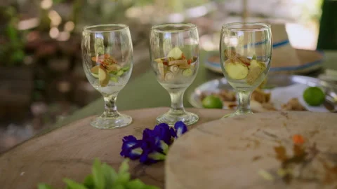 Culinary experience featuring colorful ingredients in small glasses at a garden Stock Footage 301571051