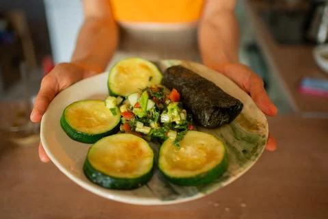 Culinary expertise highlighted through grilled zucchini slices, fresh salad Stock Photos