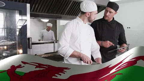 Culinary lead pointing tablet, coordinating line chef prepping while dragon Video stock 333318032