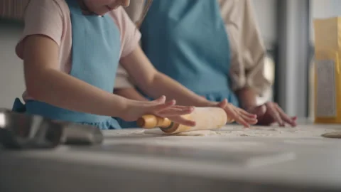 Culinary master class for children, little girl is rolling out dough for pie or Stock Footage 196083206