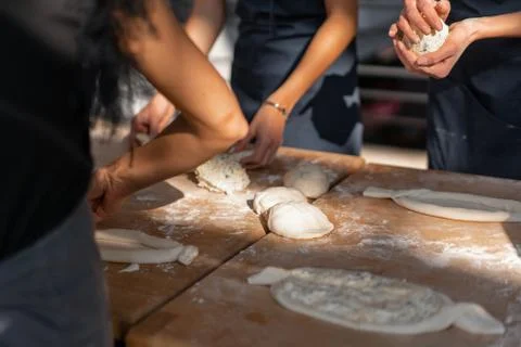 Culinary master class. Closeup of people hands preparing khachapuri. Traditio 스톡 사진