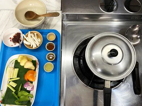 Culinary master class setup featuring fresh vegetables, spices, and cooking Stock Photos