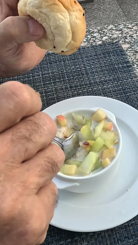 A Culinary Moment: A Close-Up of a Hand Holding a Soft Roll While Preparing to 库存影片 331116489
