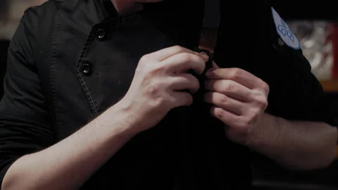 Culinary Preparation: Chef Puts on Apron Stockbeeldmateriaal 307075121