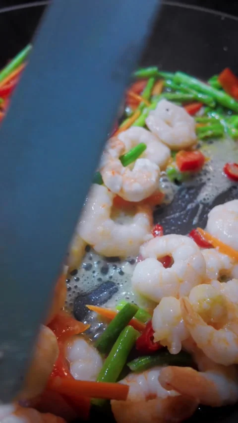 Culinary Preparation of Shrimp and Vegetable Stir Fry in Frying Pan Video stock 330592682