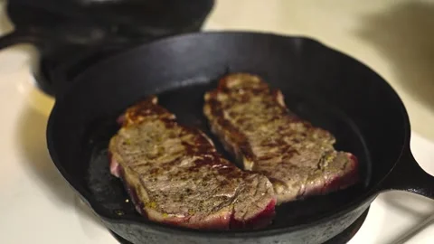 Culinary process captured with focus on heat, movement, and surface texture 動画素材 333718851