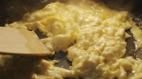 A culinary spatula stirring a cooked delicate omelet in a frying pan 스톡 동영상 152649758