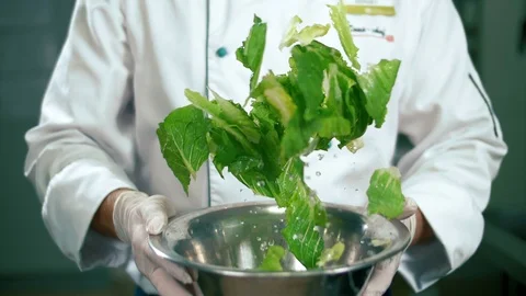 The culinary specialist mixes vegetable salad. Slow motion, close-up Stock-Footage 102660948