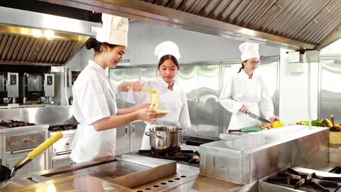 Culinary students cook fresh pasta and slice vegetables under chef supervision Video stock 313587288