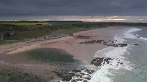 Cullen Scotland sea front beach drone aerial footage Stock Footage 247333953