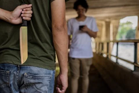 The culprit piled a knife behind while some were walking. Stock Photos