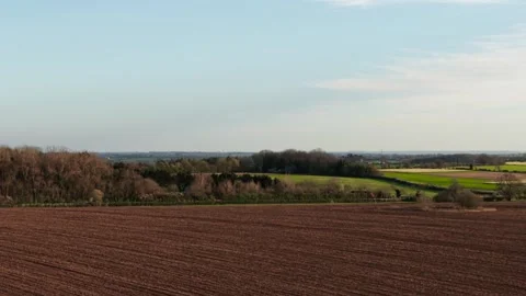 Cultivated field with dark soil texture spreading toward horizon across Video stock 344538293