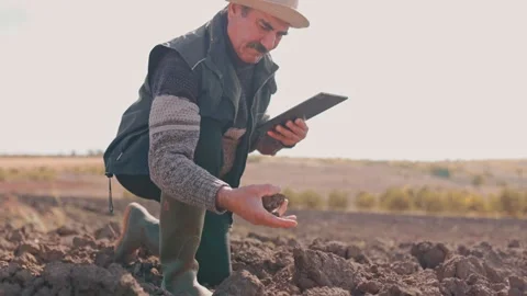 Cultivating Knowledge Elderly Farmer Using Digital Tablet in the Field Stock Footage 281546138
