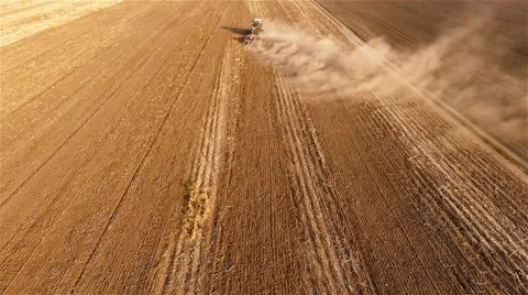 Cultivation soil: flight over tractor plowing field harvesting HD aerial video Stock Footage 68583406