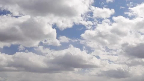 Culumus clouds pass by overhead with patches of blue showing here and there Stock Footage 182022656