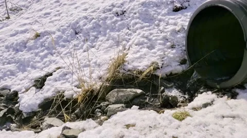 Culvert Drain with Snow running in Spring around Snowmelt Stock Footage 150663013