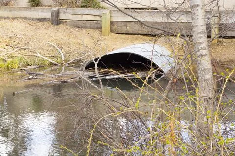 Culvert Pipe Under Road From Stream Oxbow in Park Stock Photos