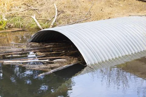 Culvert Pipe Under Road From Stream Oxbow in Park Stock Photos