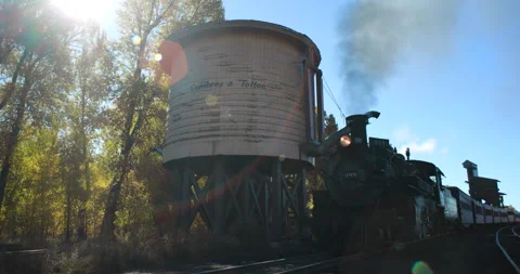 Cumbres And Toltec Steam Engine with Watertower With Fall Colors Stock Footage 259674231