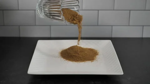 Cumin is poured onto platter in slow motion. Stock Footage 140267861