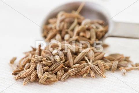 Cumin seeds and spoon Stock Photos