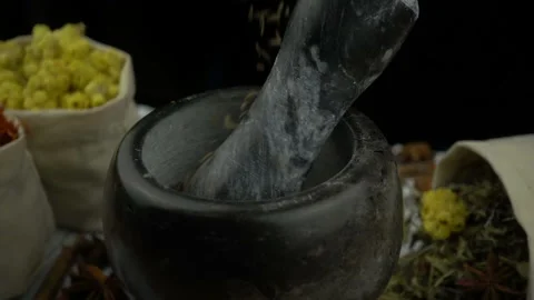 Cumin seeds falling into the granite mortar with pestle in slow motion. Healthy Stock Footage 132667324
