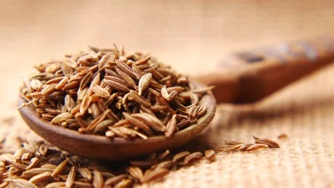 Cumin seeds on spoon on table , close up Stock Footage 167360272