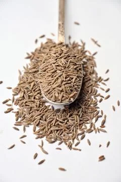 Cumin Seeds in Spoon Vertical Image Angled Top View with Defocus Background.. Stock Photos