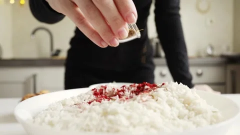 Cumin seeds sprinkled over white rice for aromatic savory dish Video stock 332791693
