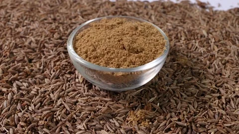 Cumin spice whole powdered in mini glass bowl pan rotate Stock-Footage 249297804