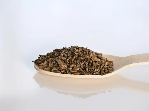 Cumin on a teaspoon spice used in the kitchen, macro photo many details, whit Stock Photos