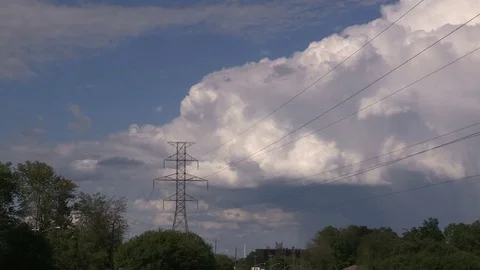 Cumulonimbus thunderstorm cloud over farm field Stock Footage