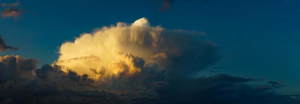 Cumulus and cumulonimbus clouds at sunset Stock Photos