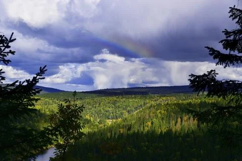 A cumulus cloud with rain, snow pellets and the remnants of a rainbow over th Stock Photos